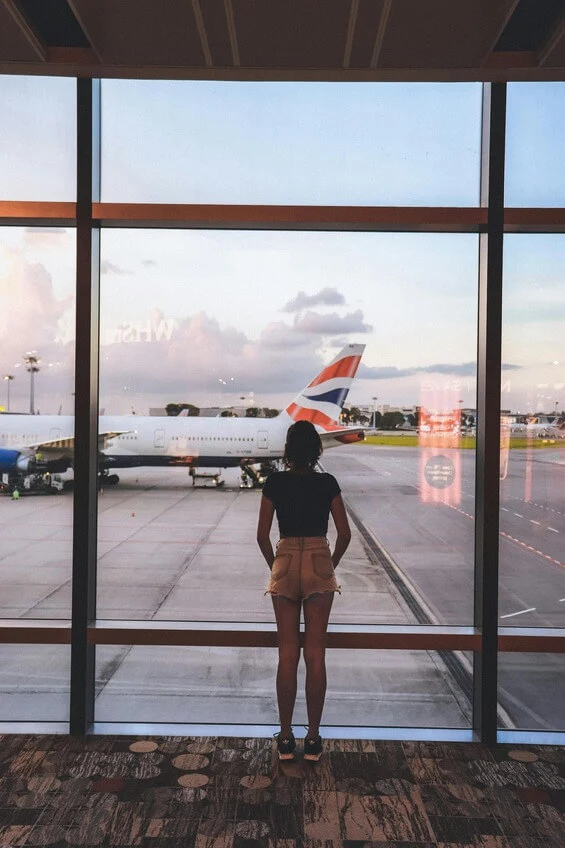 woman in the airport looking outside woman in the airport looking outside